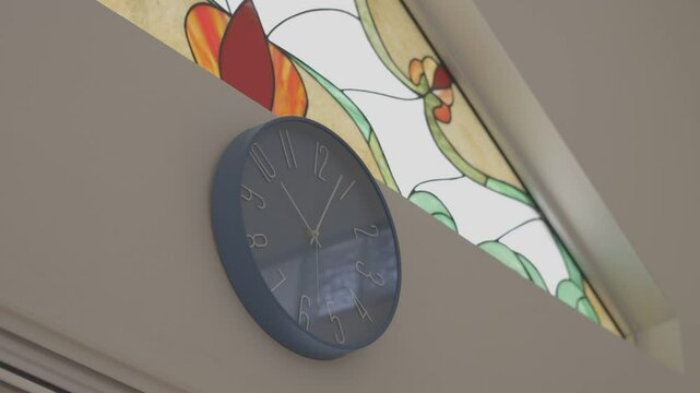 static shot focused on a clock with a beautiful stained glass window, canon eos r 8bits color raw, 4k resolution