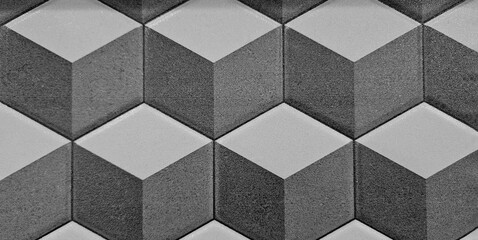 Seamless pattern of gray and black geometric shapes wall or background. Grey tile floor.