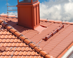 house with a roof from a red shingles with a pipe