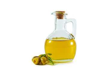 Extra virgin olive oil in a transparent jug and green olives with leaves.