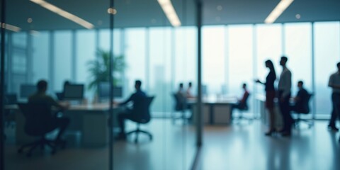 Blurred IT Team Working at Desks Behind Glass Partition