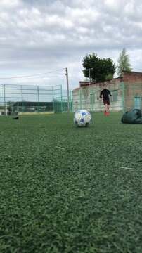 Soccer field with green turf and cloudy sky above
