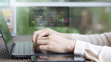 Working on a laptop with digital interface overlay.