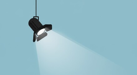 A single spotlight hangs from the ceiling, casting a bright beam of light against a pale blue background