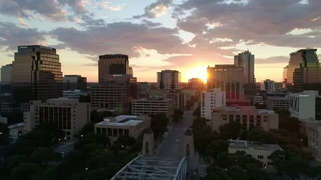 Golden sunset paints austins skyline, a fiery glow illuminating the city across the river