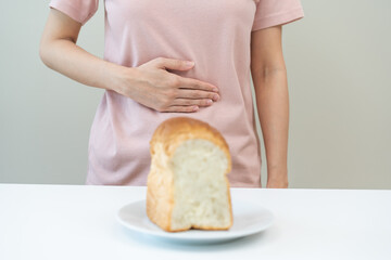 Gluten allergy, asian young woman, girl having a stomach ache hand holding, refusing to eat white...