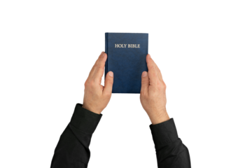 Hands holding Holy Bible book. Sacred scripture. Isolated background