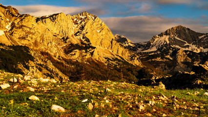 Sutjeska National Park in Bosnia and Herzegovina. Sunset in the mountains of Bosnia in the area of Prijevor and Veliki Maglic. Illuminated mountain massif on the border with Montenegro