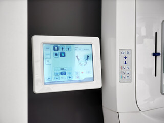 Close-up of the control panel of a modern X-ray machine for 3D panoramic scanning of a human head.