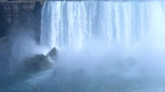 Beautiful view of Horseshoe Falls, largest of three waterfalls of Niagara Falls. Cloud of water rises nearby. View from Canadian side.