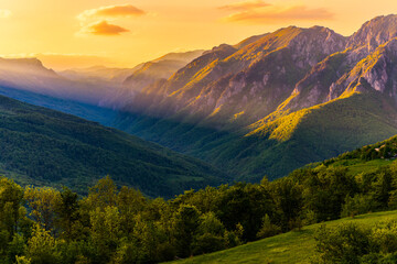 Fototapeta premium Sutjeska National Park in Bosnia and Herzegovina. Sunset in the mountains of Bosnia in the area of Prijevor and Veliki Maglic. Illuminated mountain massif on the border with Montenegro