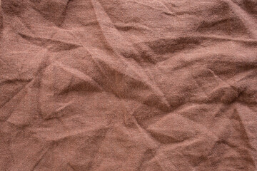 Brown wrinkled  close up fabric, abstract rustic textured backdrop