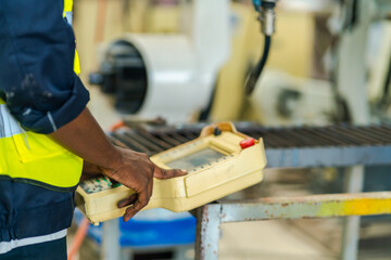 An industrial worker operates machinery in a modern factory environment focusing on production processes quality control mechanical operation workplace safety and efficient material handling