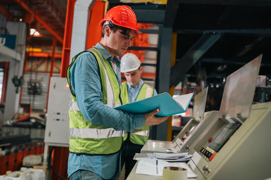 Engineers inspect industrial control systems ensuring safety efficiency and precision in a modern manufacturing environment with teamwork and technical expertise driving operational excellence