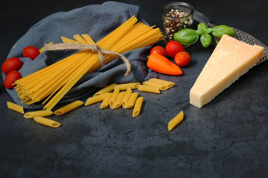 Ingredients for pasta dishes on a black background with text space.