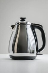 A sleek, modern electric kettle with a shiny stainless steel body and black handle, set against a plain light background.