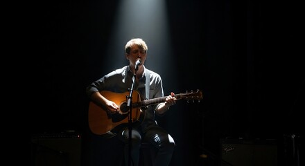 Fototapeta premium Focused Spotlight on a Musician Playing Acoustic Guitar