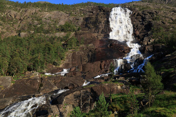 Landscape photo with a view of the cliffs and Langfossen waterfall in southern Norway