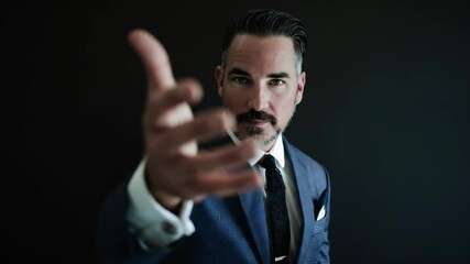 Man in blue suit extends hand for handshake or welcoming gesture. Businessman offering help, partnership, or invitation footage.