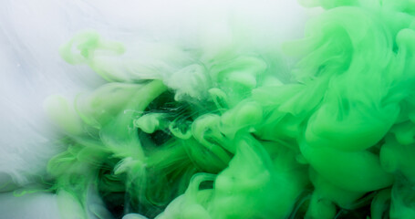 Magic fume. Paint blend. Green white swirl mystery stream. Color pigment dissolving art defocused abstract black background floating wave.