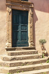 Stony Doorsteps To A Wooden Door
