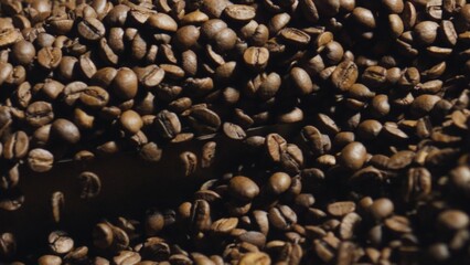 Roasted coffee beans falling and creating a pile