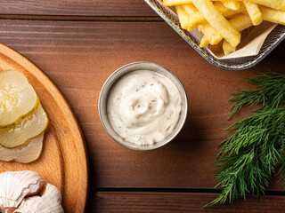 Tartar sauce in a metal sauce pan, photo for restaurant menu