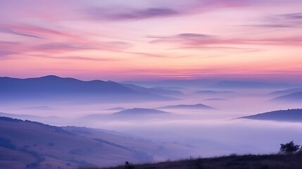 Obraz premium A delicate, serene sunrise over the Carpathians, pale pink and lavender sky, thin streaks of clouds glowing softly, mist covering the valleys, the scene exuding calm and peace.