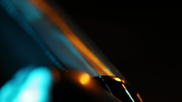 Extreme macro shot of a traditional ethnic stringed instrument. The camera slowly reveals details of the tuning pegs, strings, and fretboard with moody lighting.