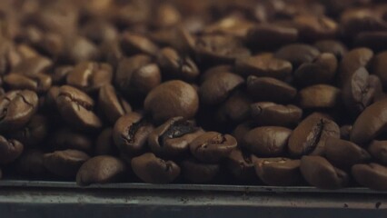 Roasted coffee beans piled up and filling the