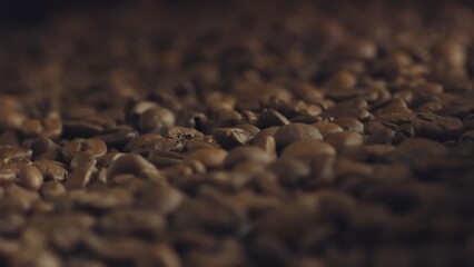 Roasted coffee beans spread out, filling frame