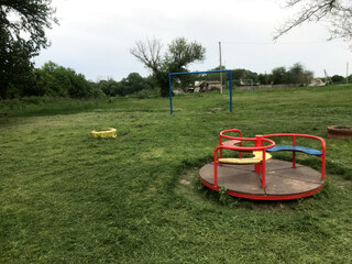 Children's play area with equipment surrounded by greenery