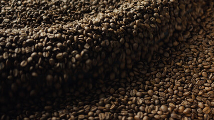 Roasted coffee beans falling and creating a small