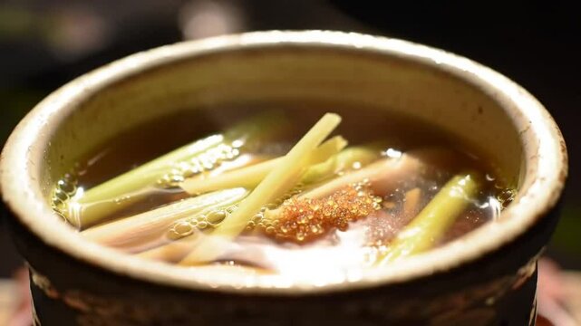 Authentic Indonesian Herbal Drink Jamu Served in a Rustic Clay Bowl Display