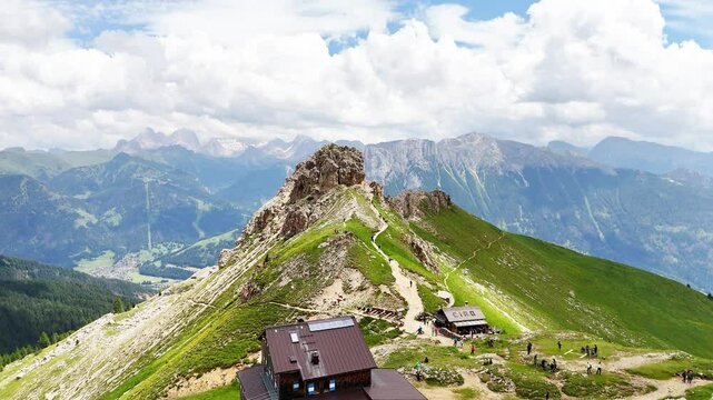 11 july 2024, Rotwandh&uuml;tte, Italy. Aerial, forward drone flight near Rotwandh&uuml;tte ( Rifugio Roda di Va&egrave;l). Hikers on the hiking trails around the mountain hut. Wonderful hiking destination in the Dolo