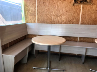 A small, bright seating area with wooden walls.