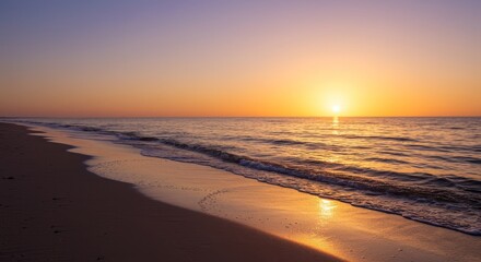 Obraz premium Serene Sunrise Beachscape - Tranquil sunrise over a calm ocean, golden light reflecting on the wet sand. Peaceful beach scene at dawn