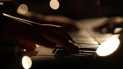 a top-down view of a pianist playing under a spotlight, and an intimate, silhouetted close-up of hands on the keys with beautiful bokeh. - Powered by Adobe