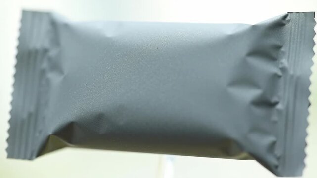 Foil Wrapped Treat: close up of candy bar sealed in foil wrapper