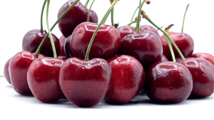 close up of beautiful red cherries on white background