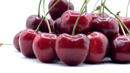 close up of beautiful red cherries on white background