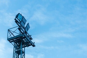 a lighting mast with floodlights powered by electricity