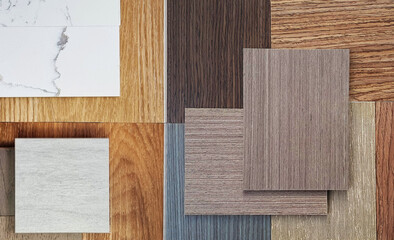interior material samples in top view includings marble quartz, wooden vinyl flooring tiles, wooden veneer, ceramic travertine stone tile in close up view. mood and tone board for design.