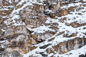A rocky mountain covered in snow