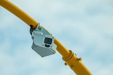 A camera is mounted on a yellow pole