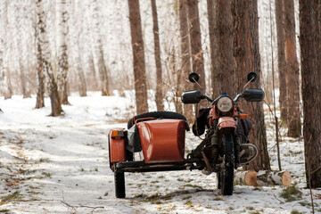 A motorcycle with a sidecar is parked in the snow