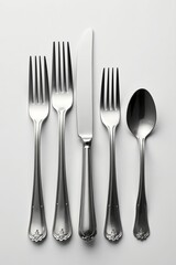 Minimalist arrangement of elegant silver cutlery, isolated, elegant