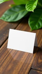 Minimalist mockup of business card with wooden background and greenery, minimalist, blank card