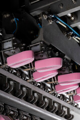 Close-Up of Pink Ice Cream Popsicles on Industrial Production Line – Frozen Dessert Manufacturing