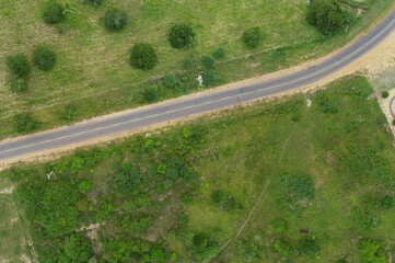 Road in the countryside between farms aerial view